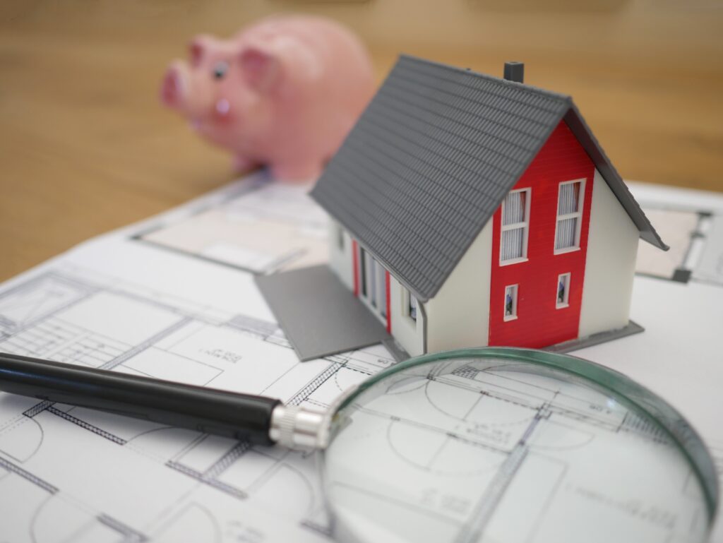 miniature house with spy glass and money bank