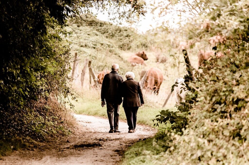 Older couple walking in a garden